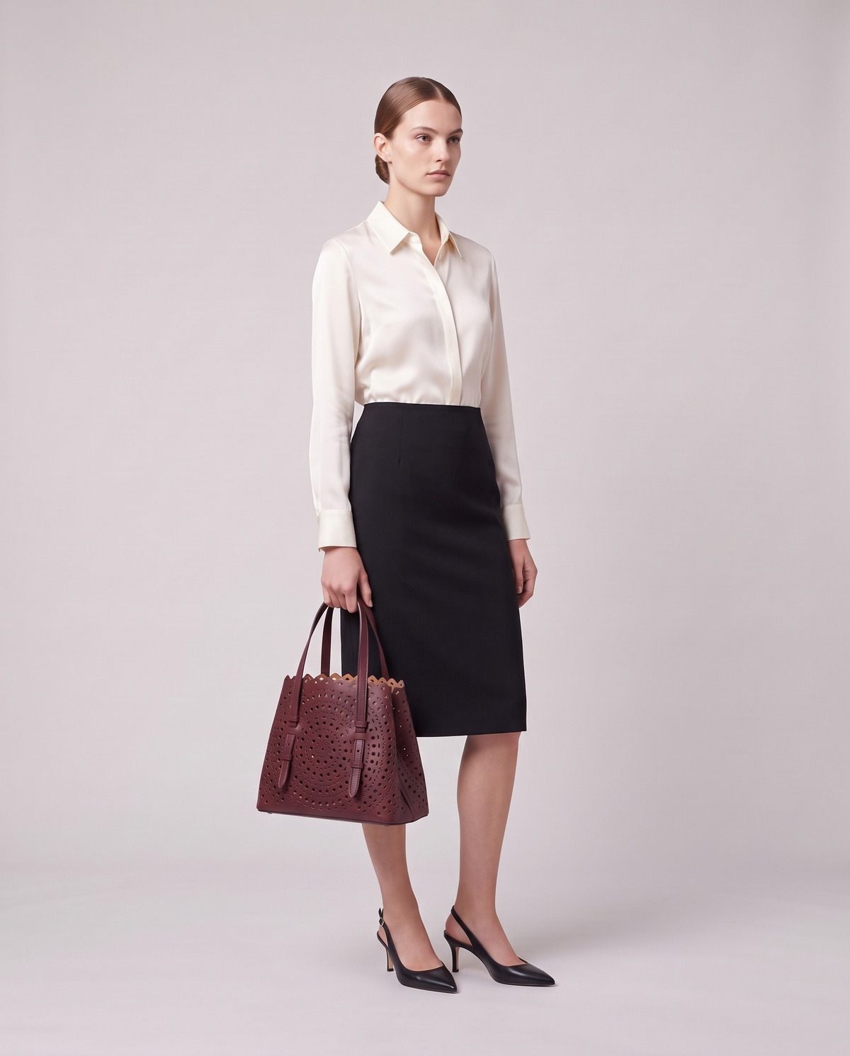 Model carrying the Valentina Urbino Medium bag in Burgundy