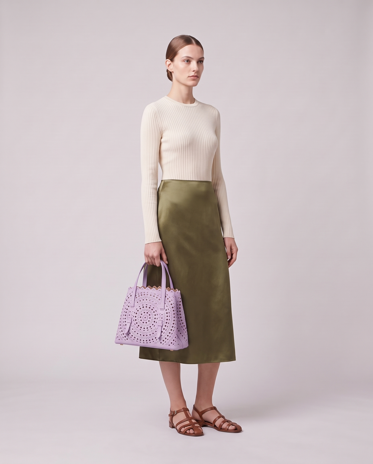 Model holding the Valentina Urbino Medium bag in Lavender, full length