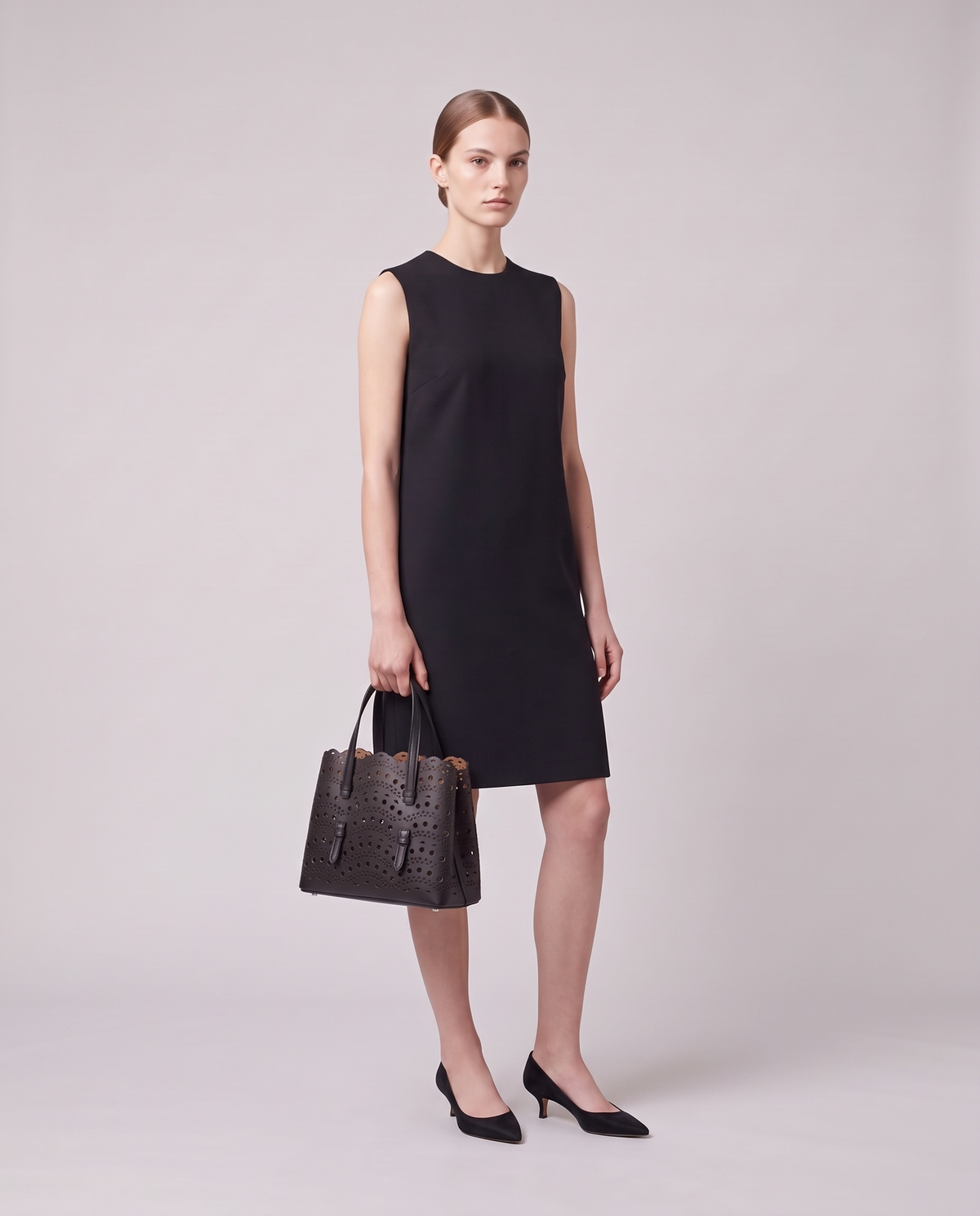 Model holding the Valentina Urbino Small bag in Black, full length