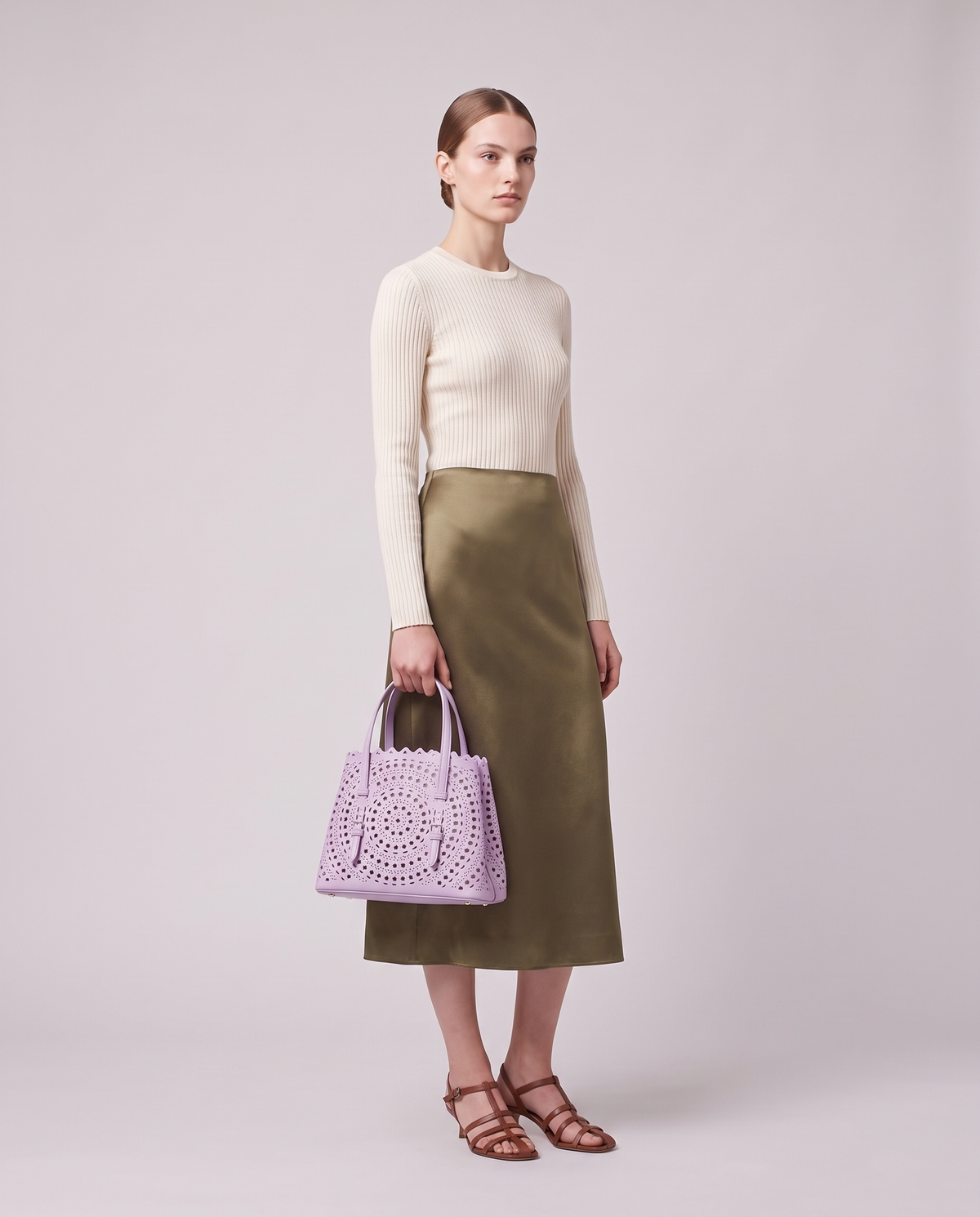 Model carrying the Valentina Urbino Small bag in Lavender