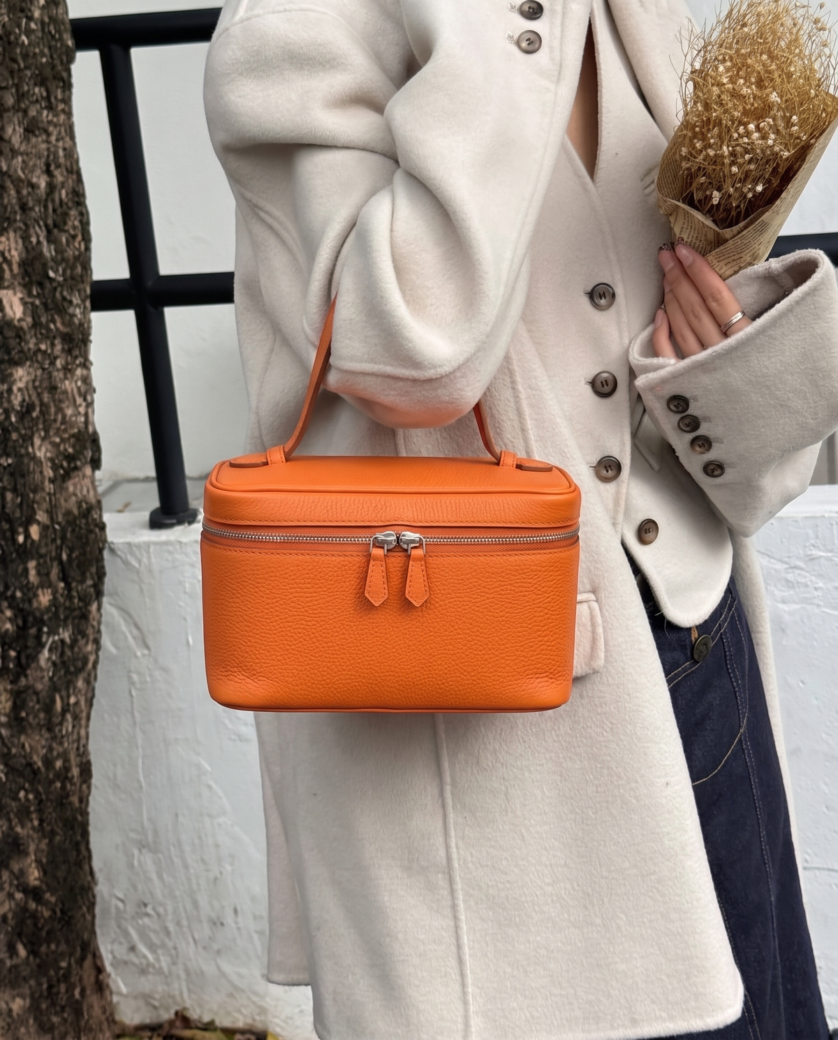 Hardware and handle detail on the Valentina Velluto Small bag in Caramel