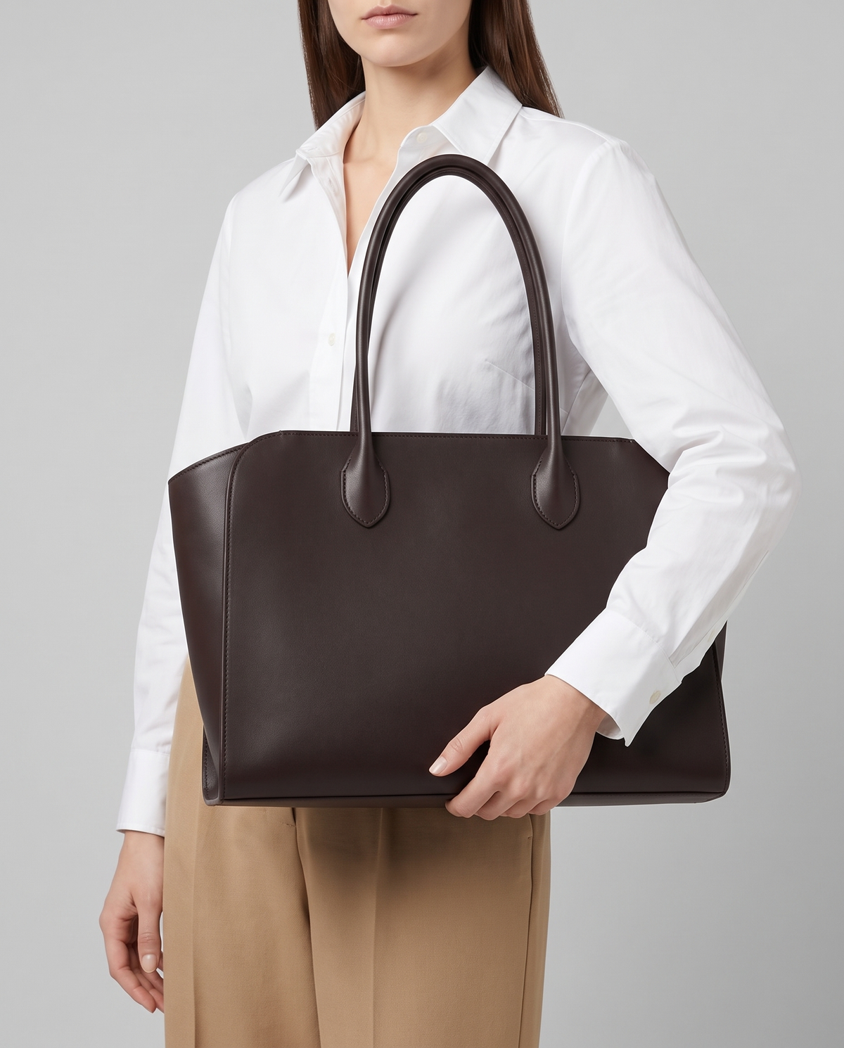Hardware and handle detail on the Valentina Volta Large bag in Espresso